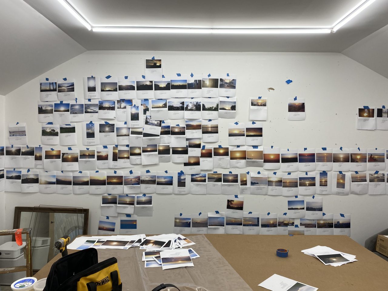 Printed photographs hanging on the wall of Ghost of a Dream's artist space.