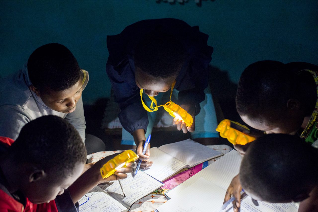 Children in Rwanda studying with Little Sun Original solar lamps. For every pair of sunglasses bought, #TOGETHERBAND will donate a solar lamp to children in Sub-Saharan Africa.